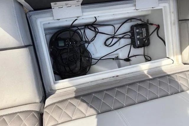 Slide: The Image of 2021 Ranger Reata 223FC boat storage compartment with electronic equipment and wiring. - 10