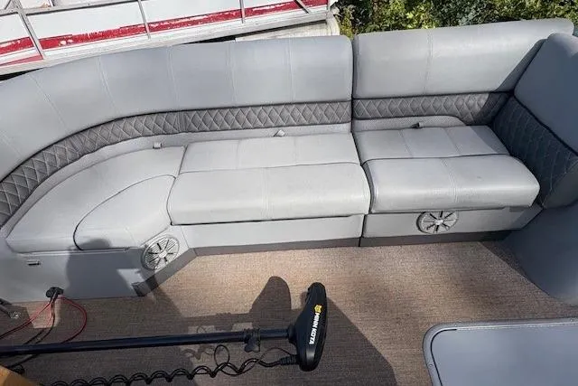 Slide: The Image of 2021 Ranger Reata 223FC boat interior with gray cushioned seating and speakers. - 13