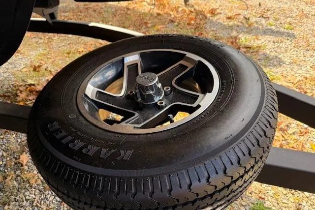 Slide: The Image of 2021 Ranger Reata 223FC trailer tire with alloy wheel on gravel surface. - 18