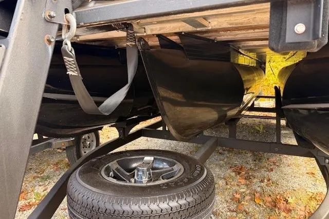 Slide: The Image of 2021 Ranger Reata 223FC boat trailer underside with spare tire and secure straps. - 19