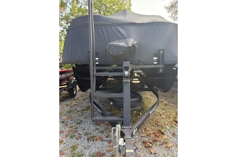 Slide: The Image of 2021 Ranger Reata 223FC boat covered on trailer, parked on gravel. - 4
