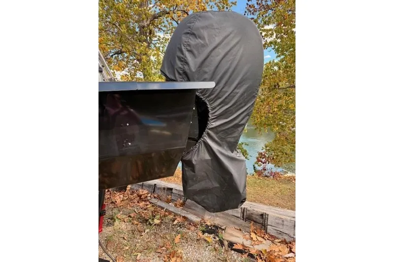 Slide: The Image of 2021 Ranger Reata 223FC boat with covered outboard motor, autumn leaves in background. - 5