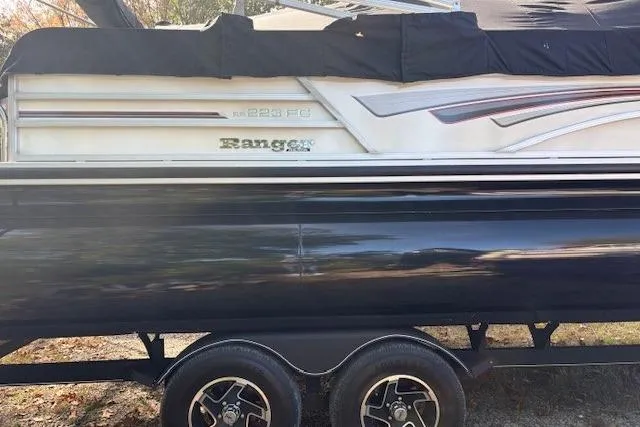 Slide: The Image of 2021 Ranger Reata 223FC boat on trailer, side view with cover. - 6