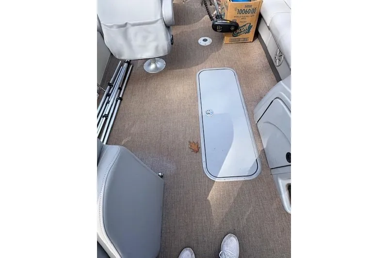 Slide: The Image of 2021 Ranger Reata 223FC boat interior with beige carpet and seating. - 9