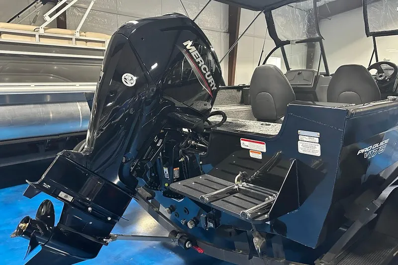 Slide: The Image of 2026 Tracker Pro Guide V-175 WT boat with Mercury outboard motor in showroom. - 4