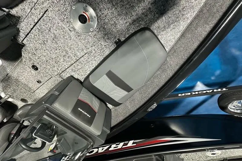 Slide: The Image of 2026 Tracker Pro Guide V-175 WT boat interior with gray seating and carpeted flooring. - 9