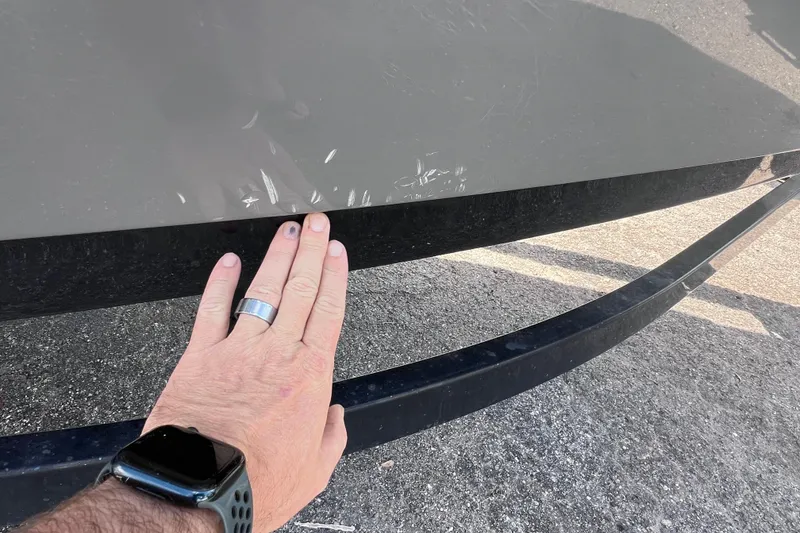 Slide: The Image of Hand inspecting scratches on 2015 Yamaha Boats SX192 hull surface. - 11