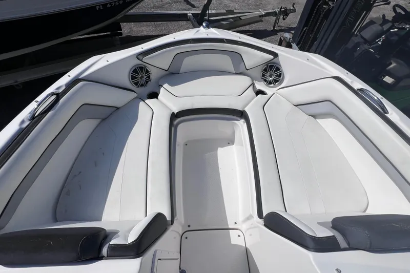 Slide: The Image of 2015 Yamaha Boats SX192 interior with white cushioned seating and speakers. - 21