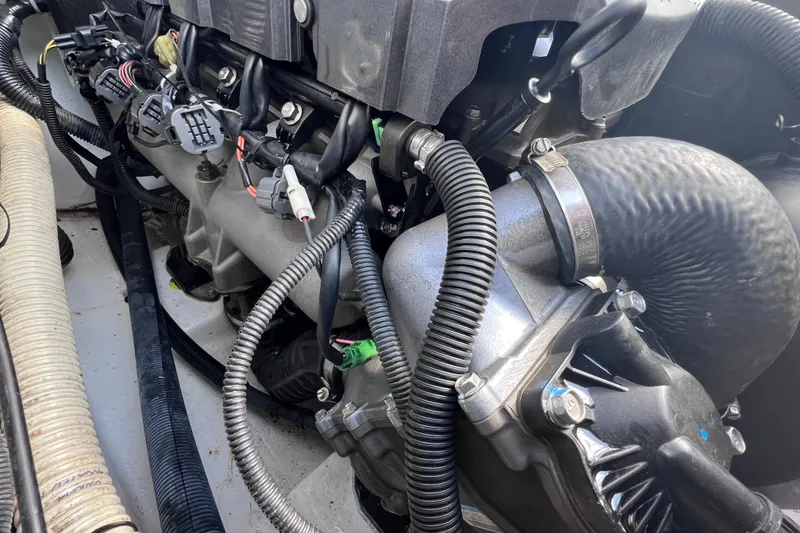 Slide: The Image of Engine components of a 2015 Yamaha Boats SX192, showcasing detailed wiring and hoses. - 27