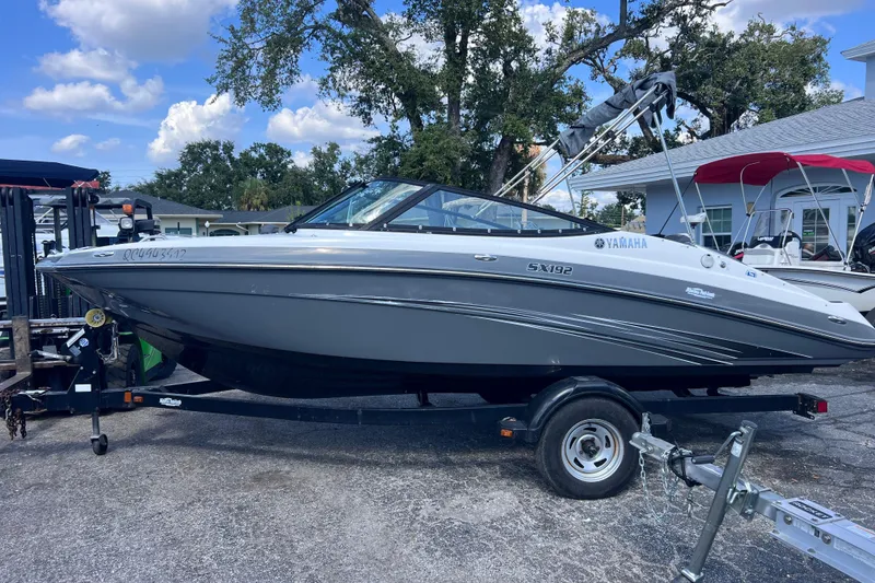 Slide: The Image of 2015 Yamaha Boats SX192 on trailer, parked outdoors under blue sky. - 6