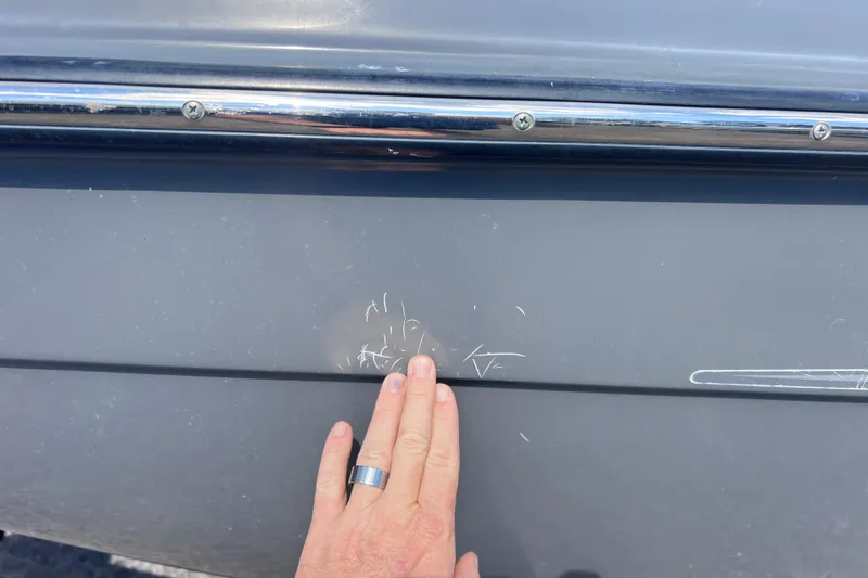 Slide: The Image of Hand inspecting scratches on 2015 Yamaha SX192 boat hull. - 7