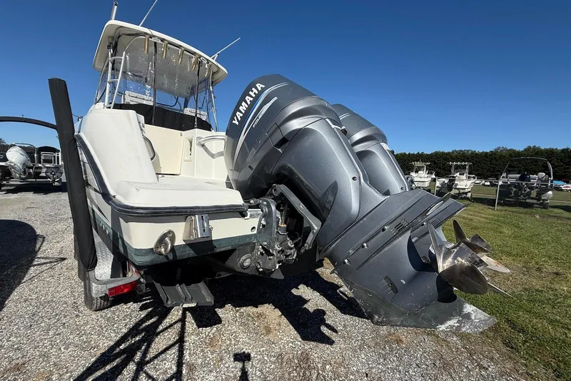 Slide: The Image of 2003 Hydra-Sports Vector 2800 WA boat with Yamaha outboard engines, parked on gravel. - 10
