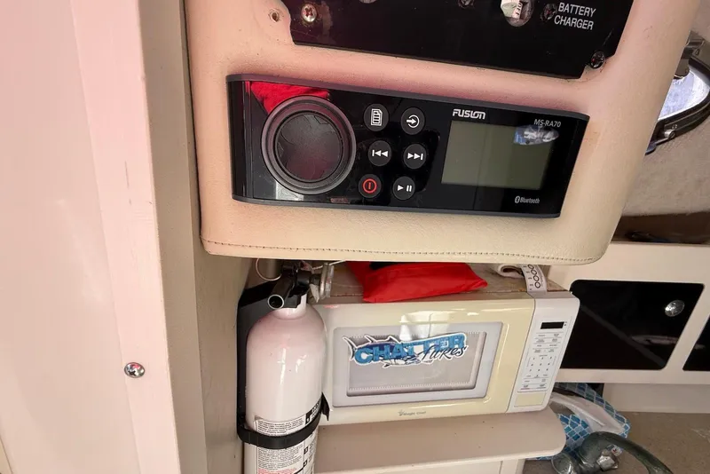 Slide: The Image of 2003 Hydra-Sports Vector 2800 WA interior with stereo, fire extinguisher, and microwave. - 15