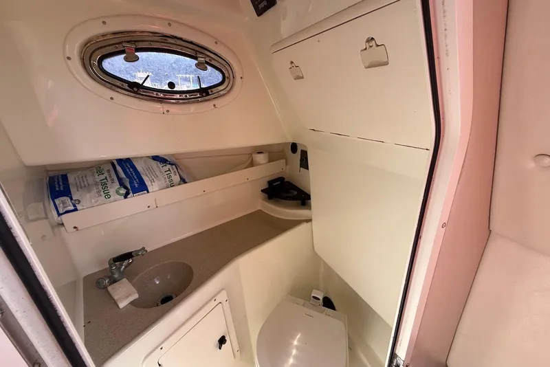 Slide: The Image of 2003 Hydra-Sports Vector 2800 WA cabin interior with sink, toilet, and storage. - 18