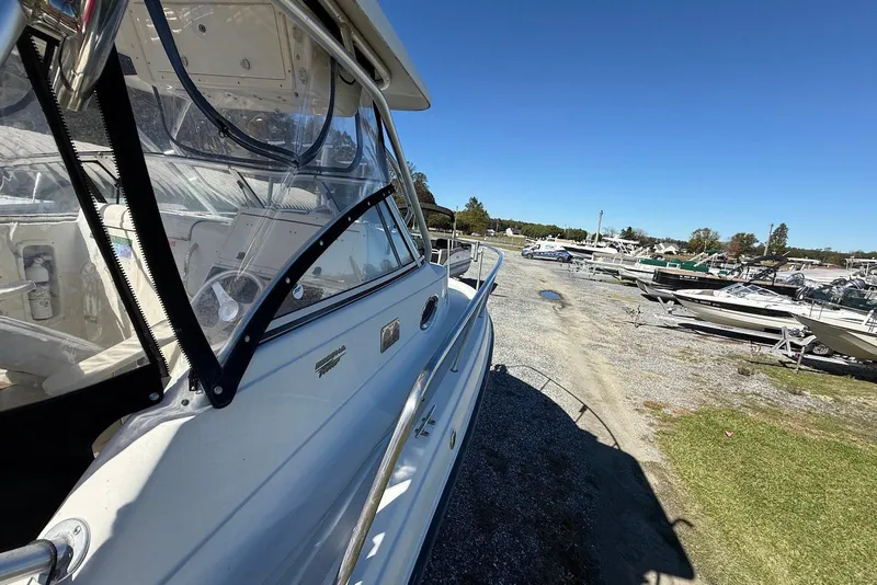 Slide: The Image of 2003 Hydra-Sports Vector 2800 WA boat in a marina, clear sky background. - 3