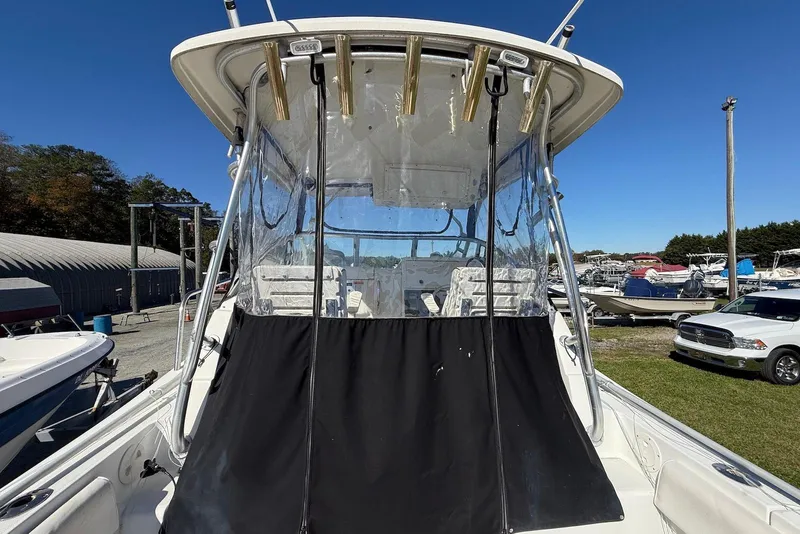 Slide: The Image of 2003 Hydra-Sports Vector 2800 WA boat with clear enclosure and rod holders, docked outdoors. - 4