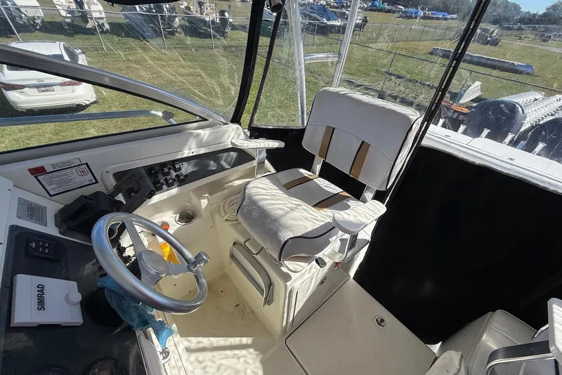 Slide: The Image of 2003 Hydra-Sports Vector 2800 WA boat cockpit with steering wheel and captain's chair. - 8