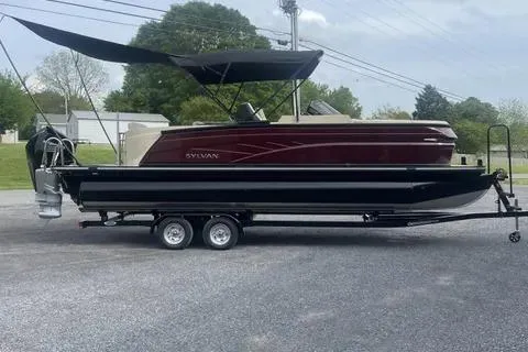The Image of 2024 Sylvan G-3 DLZ DC pontoon boat on trailer, parked outdoors. - 1