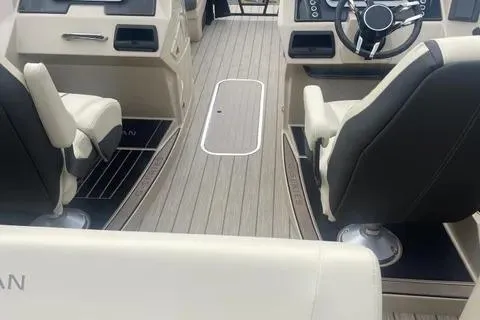 Slide: The Image of 2024 Sylvan G-3 DLZ DC boat interior with modern seating and steering wheel. - 9