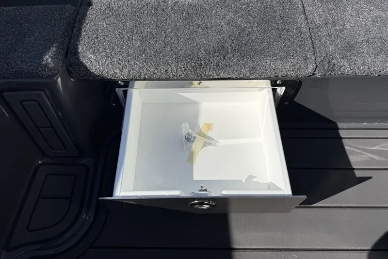 Slide: The Image of Open storage compartment in a 2026 Phoenix 920 Elite X boat. - 13