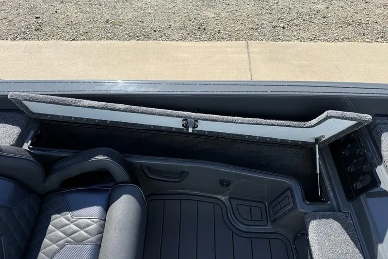 Slide: The Image of Open storage compartment in 2026 Phoenix 920 Elite X boat interior. - 14