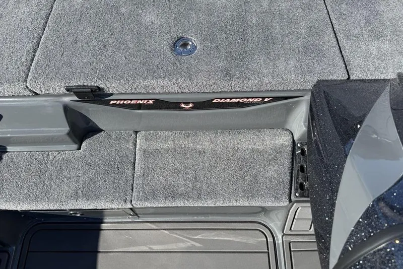 Slide: The Image of 2026 Phoenix 920 Elite X boat interior with gray carpet and "Diamond V" branding. - 16