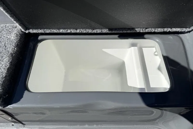Slide: The Image of Open storage compartment in a 2026 Phoenix 920 Elite X boat. - 17
