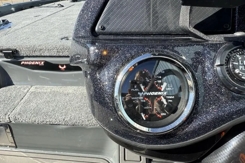 Slide: The Image of Dashboard of 2026 Phoenix 920 Elite X boat with gauges and logo. - 21