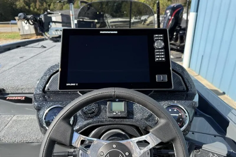 Slide: The Image of Steering console of 2026 Phoenix 920 Elite X boat with advanced navigation display. - 23