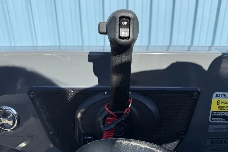 Slide: The Image of Throttle control lever on a 2026 Phoenix 920 Elite X boat dashboard. - 24