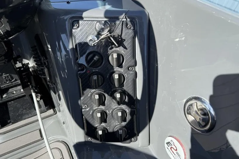 Slide: The Image of Control panel of 2026 Phoenix 920 Elite X boat with switches and key ignition. - 26