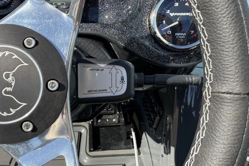 Slide: The Image of Steering wheel and controls of 2026 Phoenix 920 Elite X boat. - 28