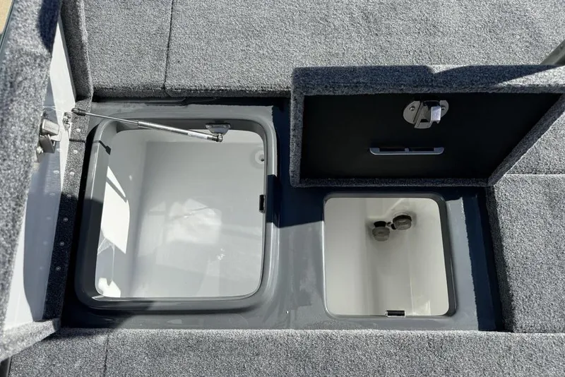 Slide: The Image of Open storage compartments on a 2026 Phoenix 920 Elite X boat deck. - 29