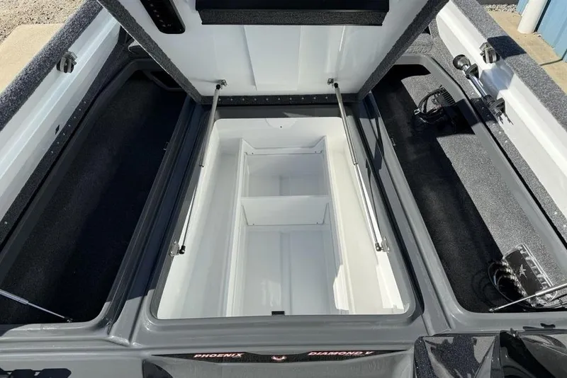 Slide: The Image of Open storage compartment of 2026 Phoenix 920 Elite X boat, showcasing spacious interior design. - 6