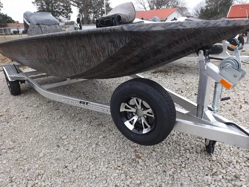 Slide: The Image of 2019 Xpress XP180 boat on trailer, parked on gravel surface. - 1