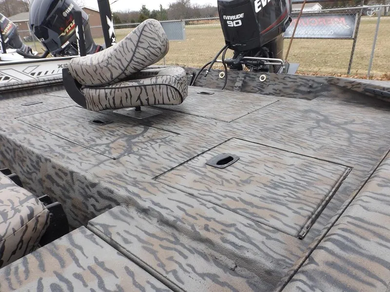 Slide: The Image of 2019 Xpress XP180 boat with camo pattern and Evinrude motor, featuring storage compartments. - 10