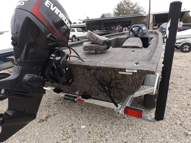 Slide: The Image of 2019 Xpress XP180 boat with Evinrude motor on gravel lot. - 11