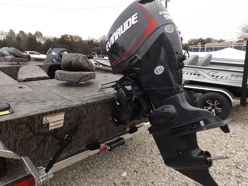 Slide: The Image of 2019 Xpress XP180 boat with Evinrude motor, parked on gravel. - 12