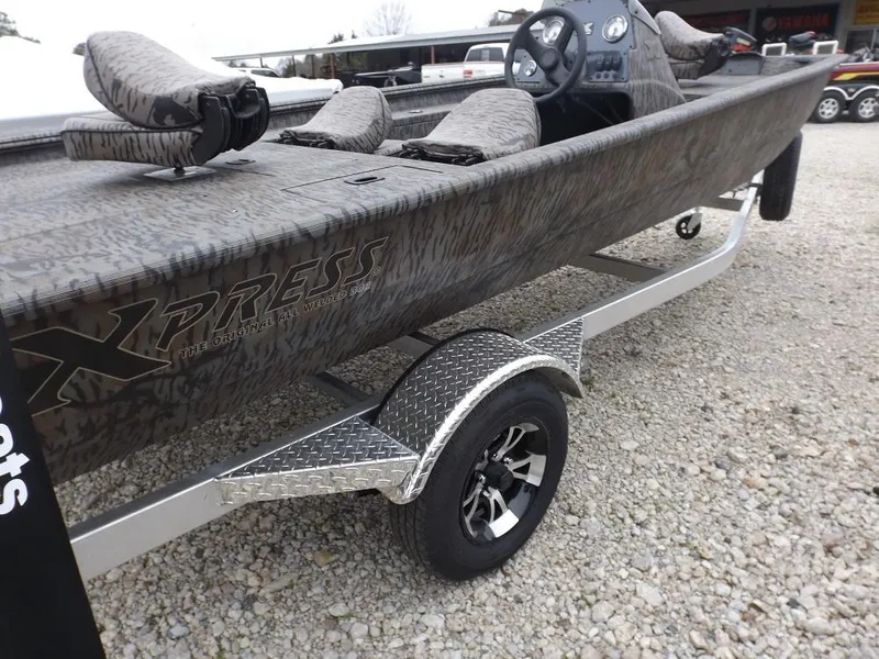 Slide: The Image of 2019 Xpress XP180 boat on trailer, featuring camouflage design and comfortable seating. - 3