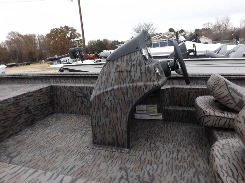 Slide: The Image of 2019 Xpress XP180 boat interior with camouflage design and steering console. - 5