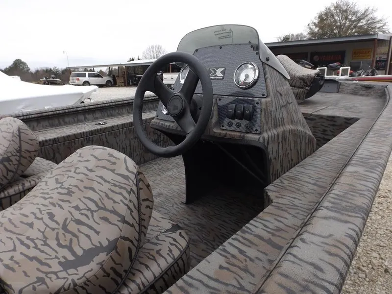 Slide: The Image of 2019 Xpress XP180 boat interior with camouflage design and steering console. - 6
