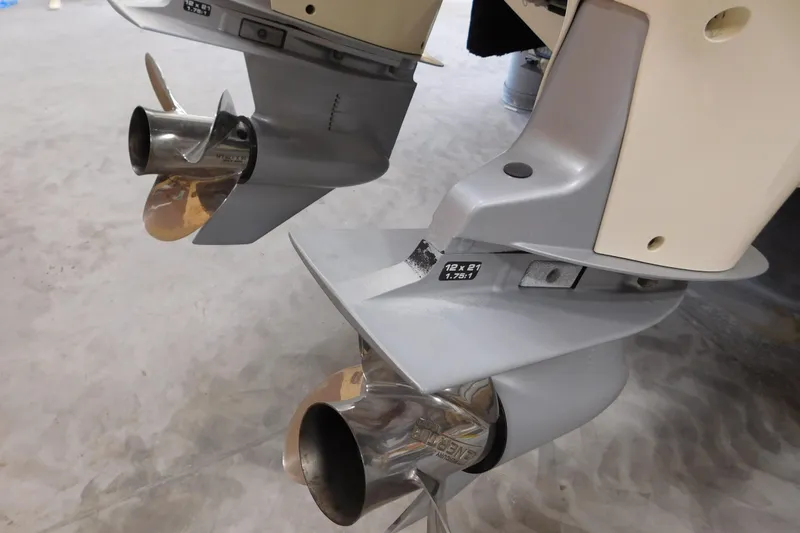 Slide: The Image of Propellers of a 2003 Regulator 32 Center Console boat in a workshop setting. - 14
