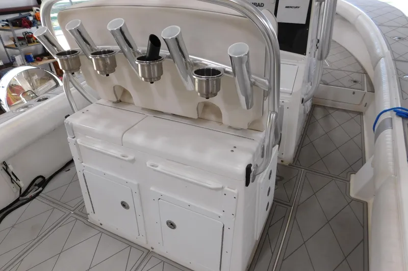 Slide: The Image of 2003 Regulator 32 Center Console boat with rod holders and storage compartments. - 16