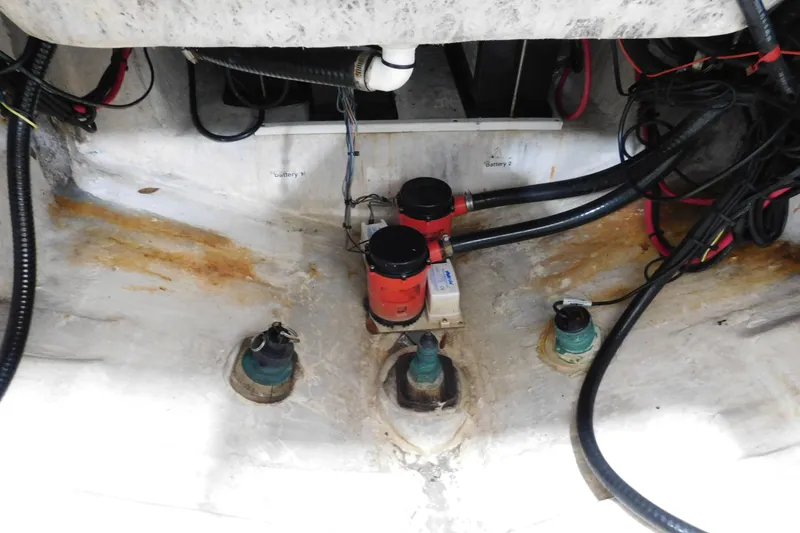 Slide: The Image of 2003 Regulator 32 Center Console bilge area with wiring and pumps. - 18