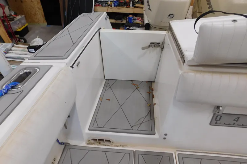 Slide: The Image of 2003 Regulator 32 Center Console boat interior with open storage compartment. - 19