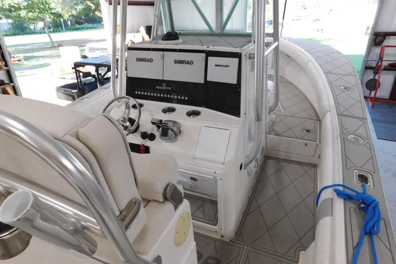 Slide: The Image of 2003 Regulator 32 Center Console boat interior with steering wheel and navigation equipment. - 23