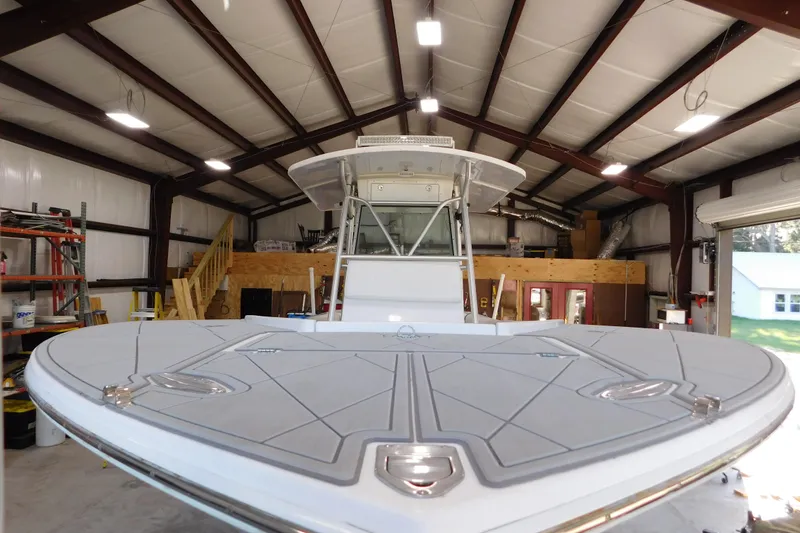 Slide: The Image of 2003 Regulator 32 Center Console boat in a spacious indoor storage facility. - 3