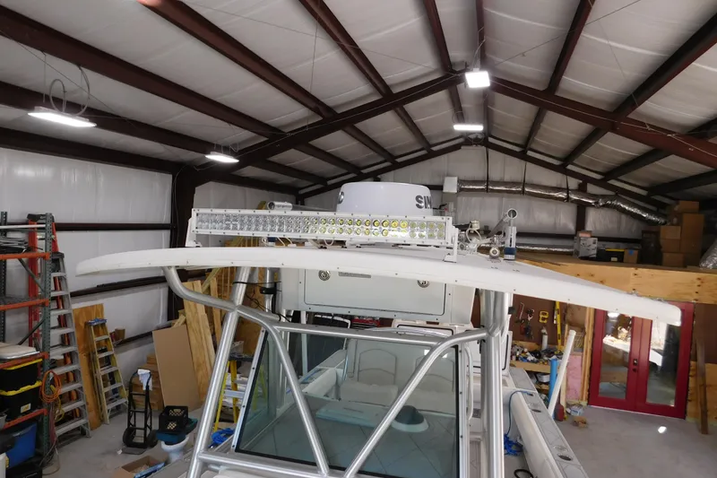 Slide: The Image of 2003 Regulator 32 Center Console boat in a workshop with LED light bar. - 34