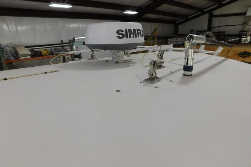 Slide: The Image of 2003 Regulator 32 Center Console boat with radar equipment in a storage facility. - 35