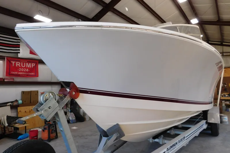 Slide: The Image of 2003 Regulator 32 Center Console boat on trailer in a garage setting. - 5